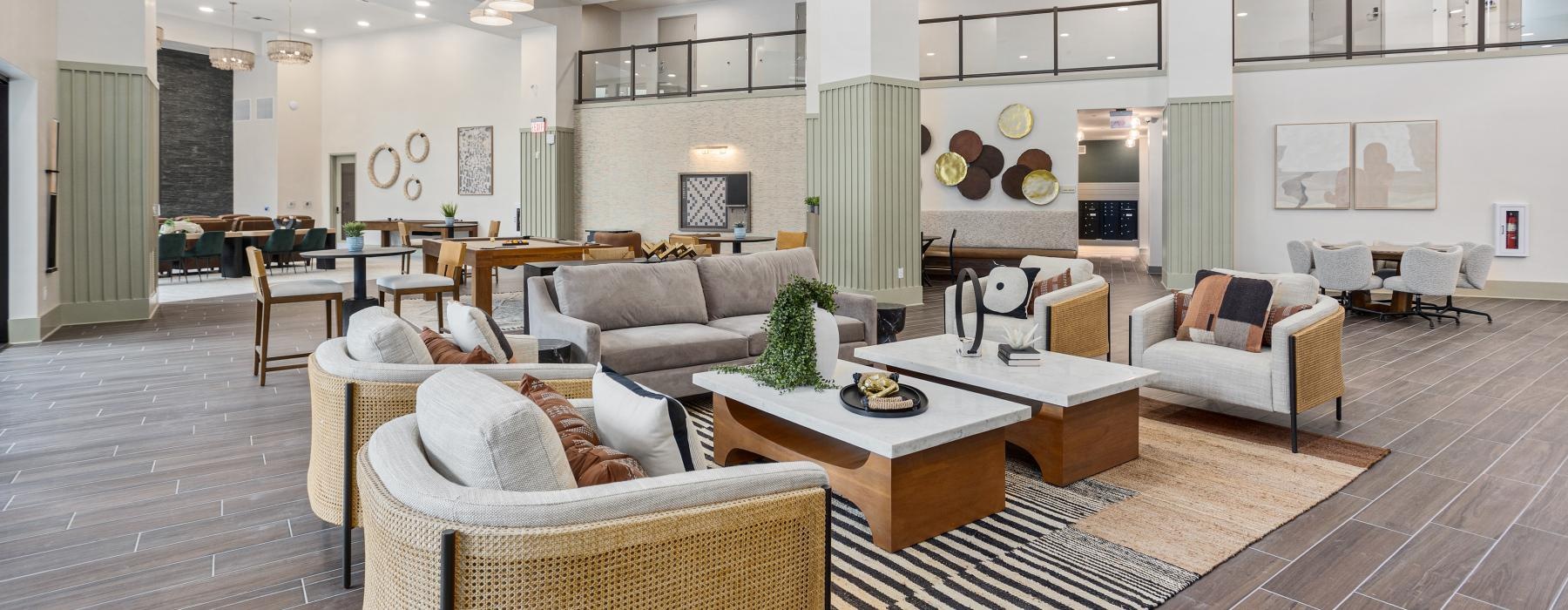 a large spacious room with a large chandelier and a large wood floor