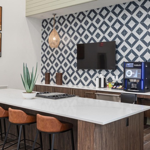 a kitchen with a bar and chairs