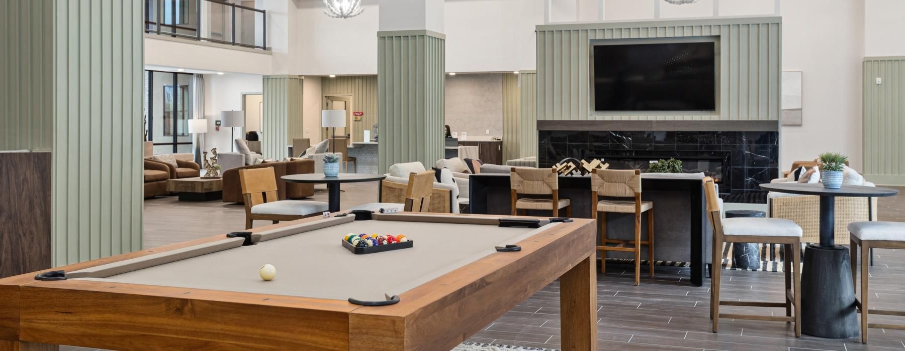 a room with a table and chairs and a billiards table